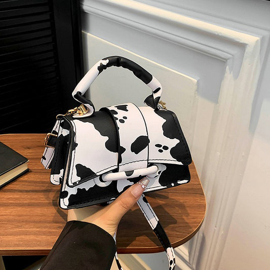 Faux leather cow print crossbody bag, Trendy animal print purse for modern outfits, Trendy handbag for teens and young adults, Women’s mini shoulder bag for going out
