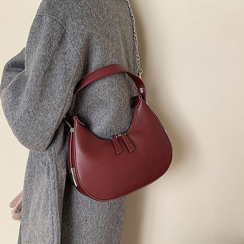 burgundy curved shoulder bag, burgundy mini shoulder bag, mini shoulder bag, curved shoulder bag