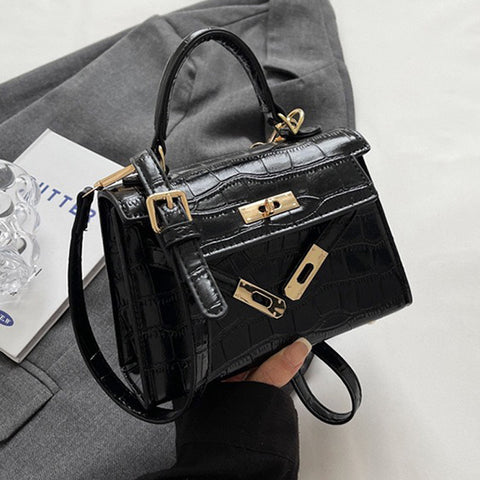 black buckle crossbody bag, black crossbody bag with an adjustable strap, buckle crossbody bag, crossbody bag with an adjustable strap