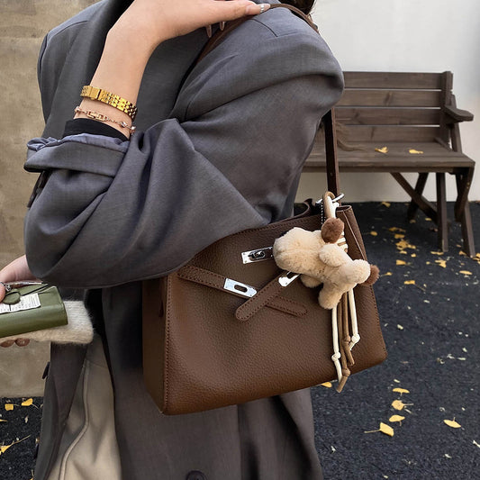 faux leather tote bag with charm, large faux leather tote bag, stylish faux leather tote bag with decorative charm, brown shoulder bag, brown shoulder tote bag