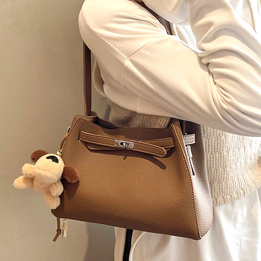 faux leather tote bag with charm, large faux leather tote bag, stylish faux leather tote bag with decorative charm, tan shoulder bag, tan shoulder tote bag
