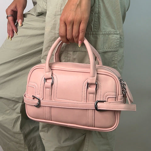 Small pink handbag with top handle and shoulder strap