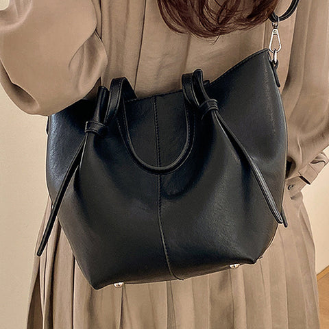 black handbag with adjustable crossbody strap