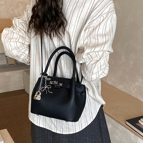 black small satchel bag with charm