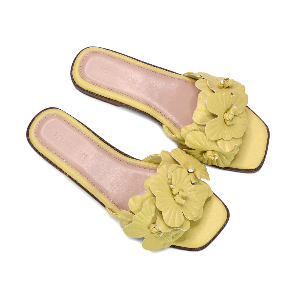 yellow resort wear slides, soft yellow open toe sandals for warm weather, yellow floral slides, yellow comfy sandals, pastel yellow summer shoes