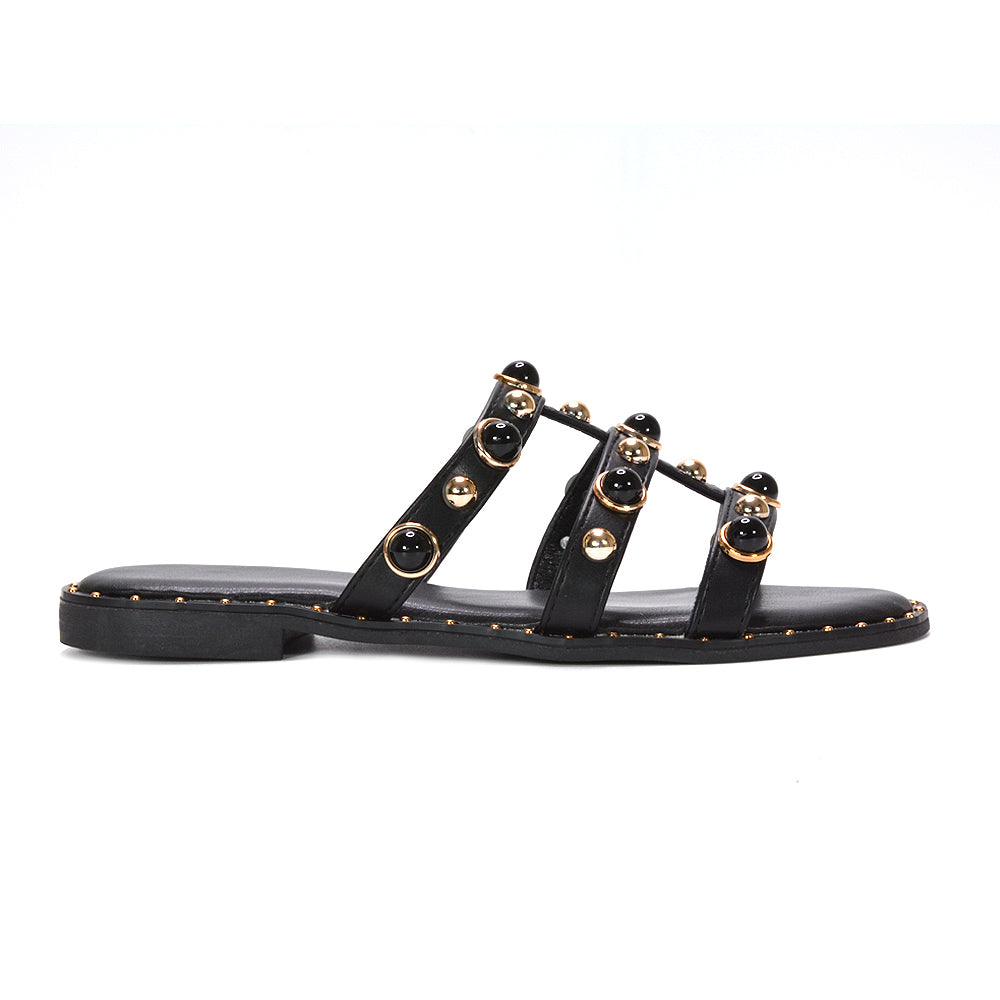 black slip on flat studded strappy sandals for women, edgy black studded strappy flat sandals women, black flat sandals for holiday evening outfits women, cushioned black flat slip on sandals for women, best black slip on flat strappy sandals for women